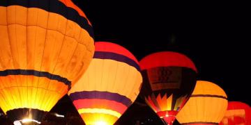 O Night Glow é um espetáculo noturno encantador, no qual balões de ar quente permanecem presos ao solo enquanto realizam uma coreografia de luzes sincronizadas. (Divulgação)